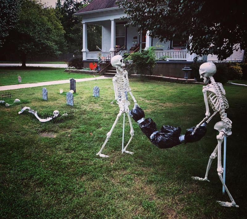 Skeletons dumping a body in flowerbeds 